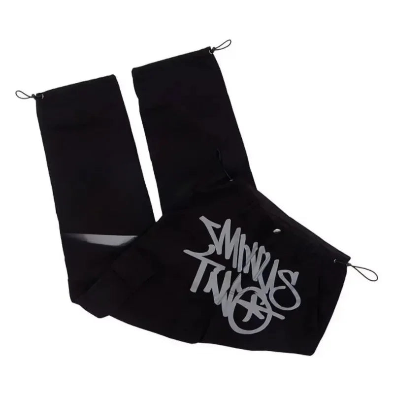 Black fabric shoe covers with silver stussy logo and drawstring closures for men dance scene pocket print casual wear