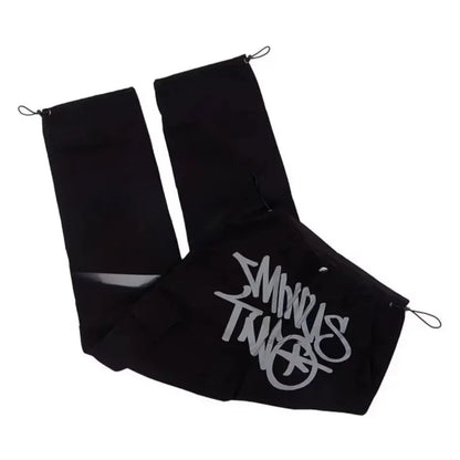 Black fabric shoe covers with silver stussy logo and drawstring closures for casual loose workwear and men dance scene