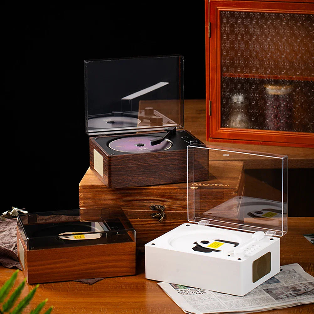 A sleek white retro cd player with a transparent lid rechargeable wireless bluetooth and music player usb features