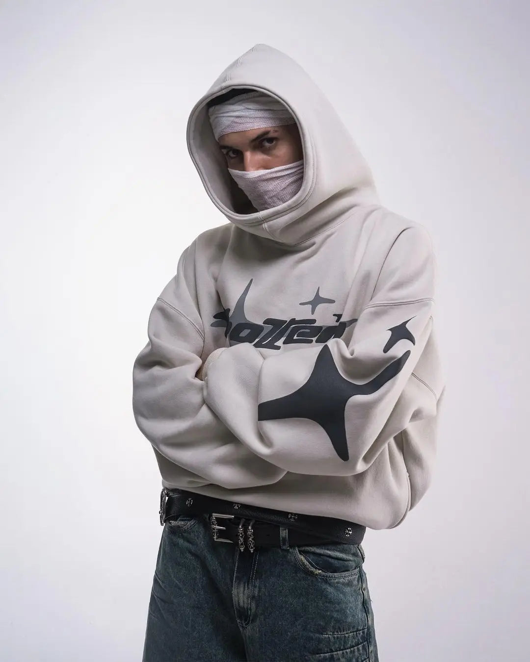 A light gray retro gothic men hoodie with black star and text graphics worn over the head street trendy2k harajuku style