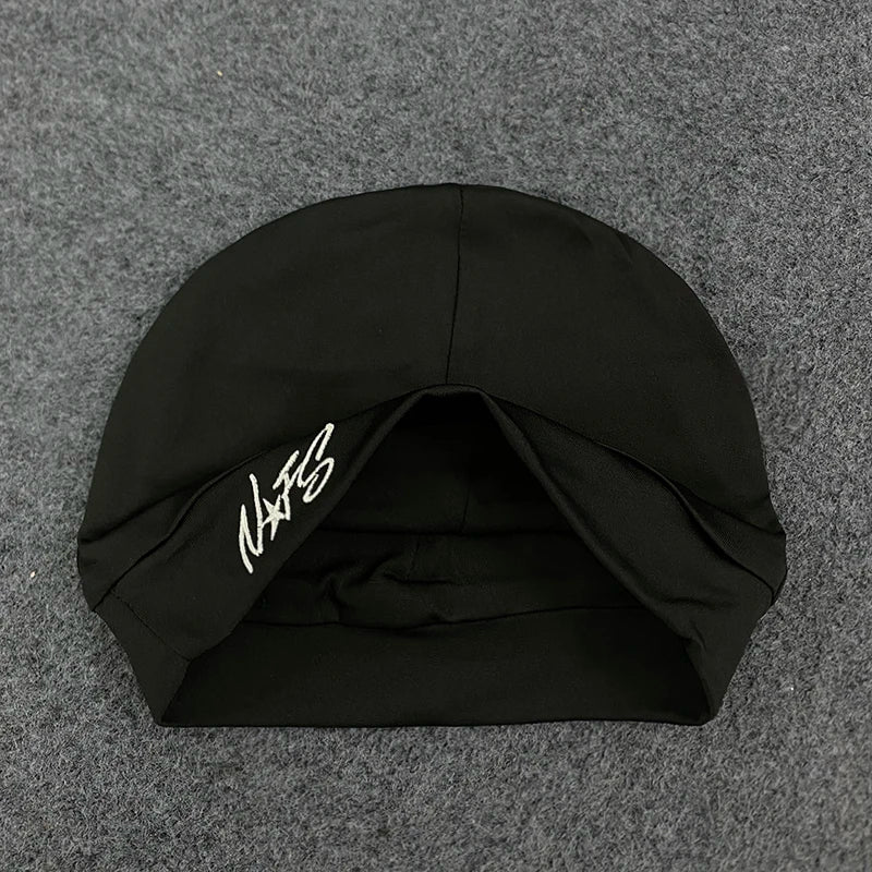 Black swim cap with white embroidered signature on the side designed for retro hip-hop streetwear fashion