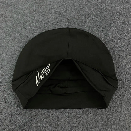 Black swim cap with white embroidered signature on the side designed for retro hip-hop streetwear fashion