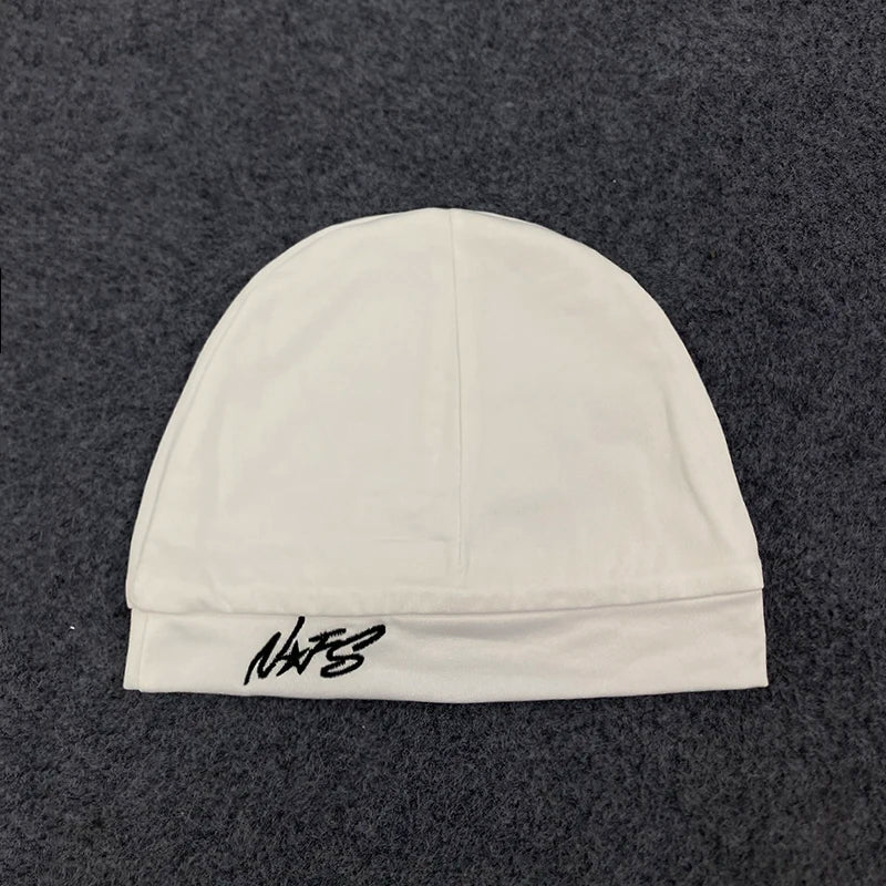 White knit beanie with black embroidered nats logo on the brim, retro hip-hop style pullover for streetwear fashion