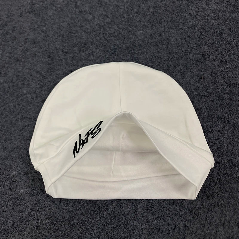 White swim cap with black embroidered nats logo featuring retro hip-hop letter design for trendy casual streetwear