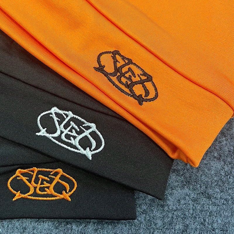 Orange black and dark gray knit pullover hat trendy with embroidered letter cap logo for fashionable streetwear