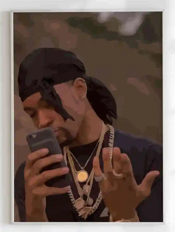 A framed canvas portrait of a man with gold chains and a black headwrap holding a smartphone for room decor