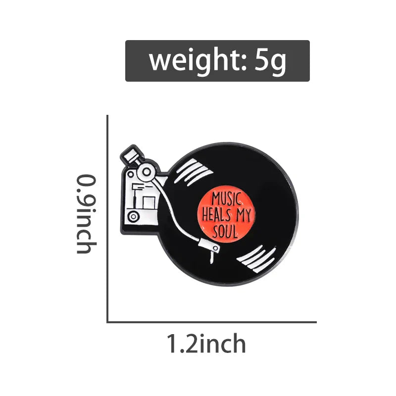 Black enamel pin featuring a retro music records vinyl design with orange center label and music heals my soul text