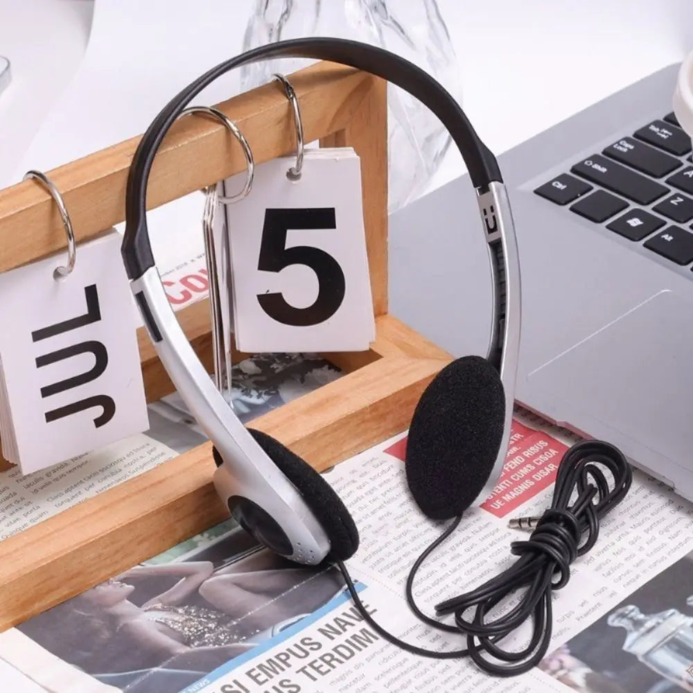 Black and silver retro wired headphones with padded earcups and coiled cable embody hip hop trends and walkman earphone personality