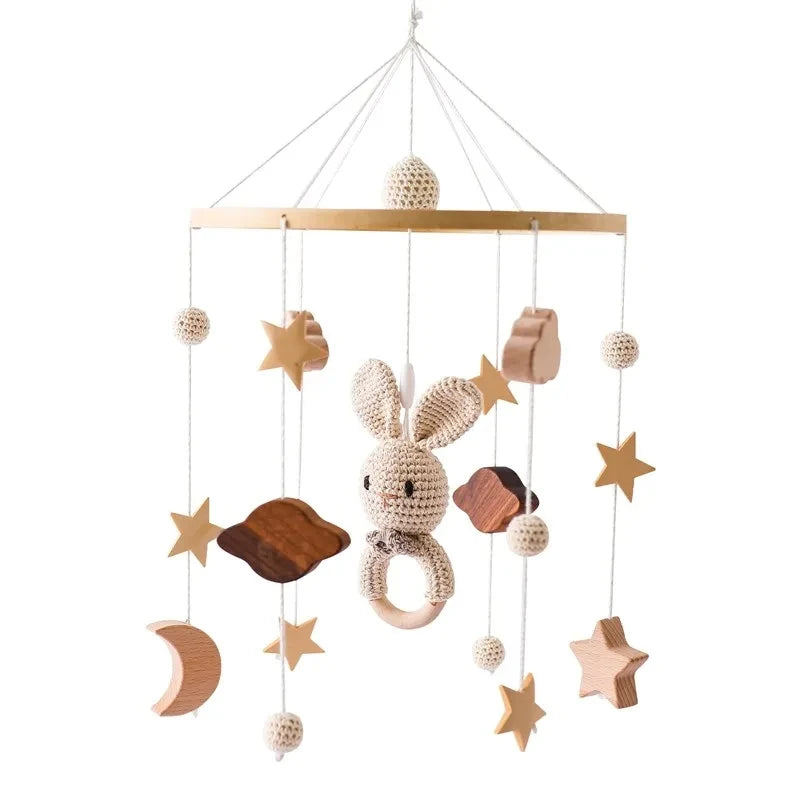 Beige crocheted bunny revolving music box with wooden ring and natural wood stars for newborns baby crib rattle baby soothing