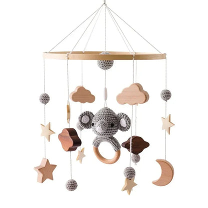 Gray crocheted koala revolving music box with wooden ring and natural wood accents for newborns baby crib rattle soothing toy