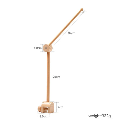 Lightweight wooden desk lamp with adjustable arm and clamp base next to revolving music box for newborns baby crib rattle baby soothing toy