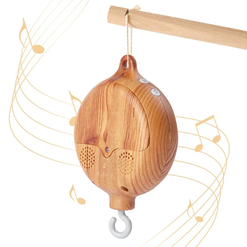 A light brown wooden revolving music box with rounded speakers for newborns baby crib rattle baby soothing toys