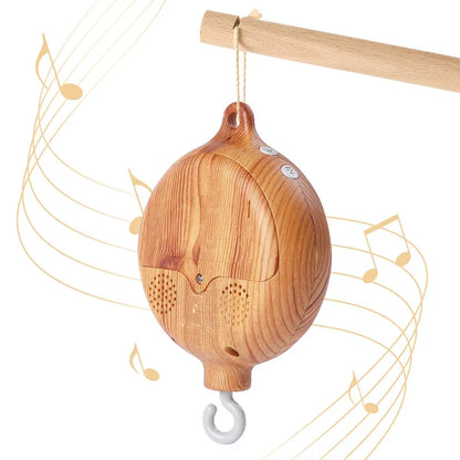 A light brown wooden revolving music box with rounded speakers for newborns baby crib rattle baby soothing toys