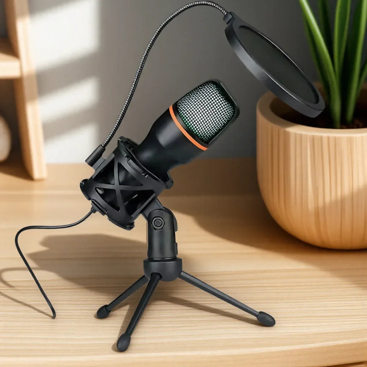 Black condenser rgb lighting microphone with orange accent and mesh grille on tripod stand professional for streaming youtube podcasts