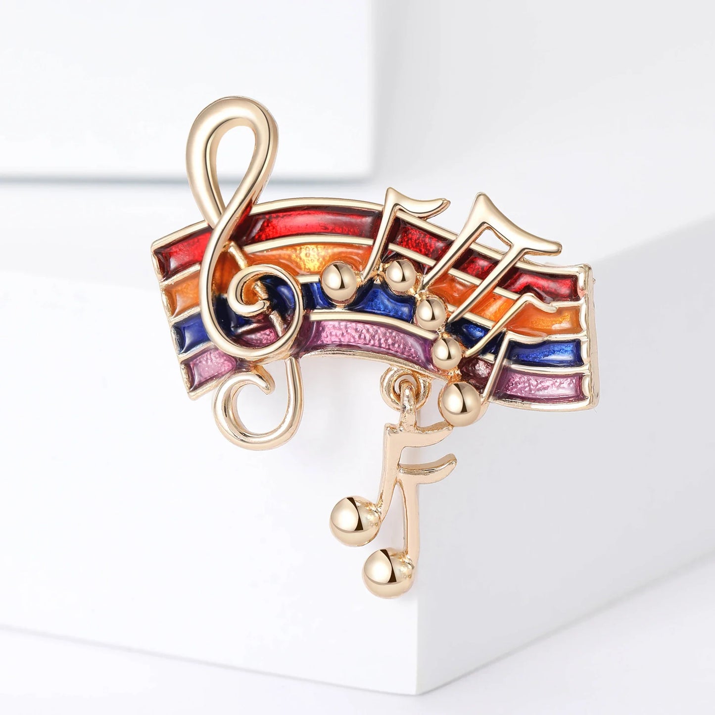 A gold-tone shiny glass musical note brooch with rainbow enamel and dangling beads for event party backpack or clothes accessory