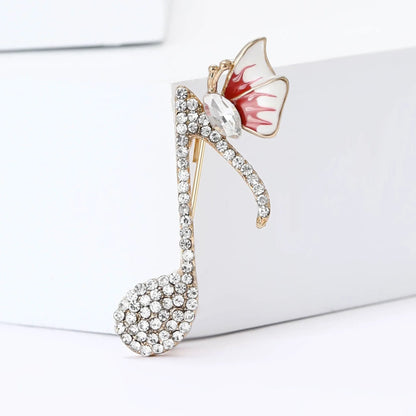 A sparkling gold-tone rhinestone butterfly pin with clear crystals and a red-and-white enamel butterfly for event party backpack decoration