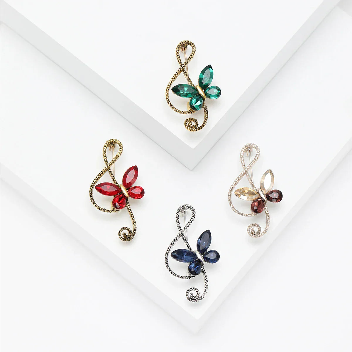 Four rhinestone butterfly pins with shiny glass musical note designs in green red blue and amber for event party backpack decoration
