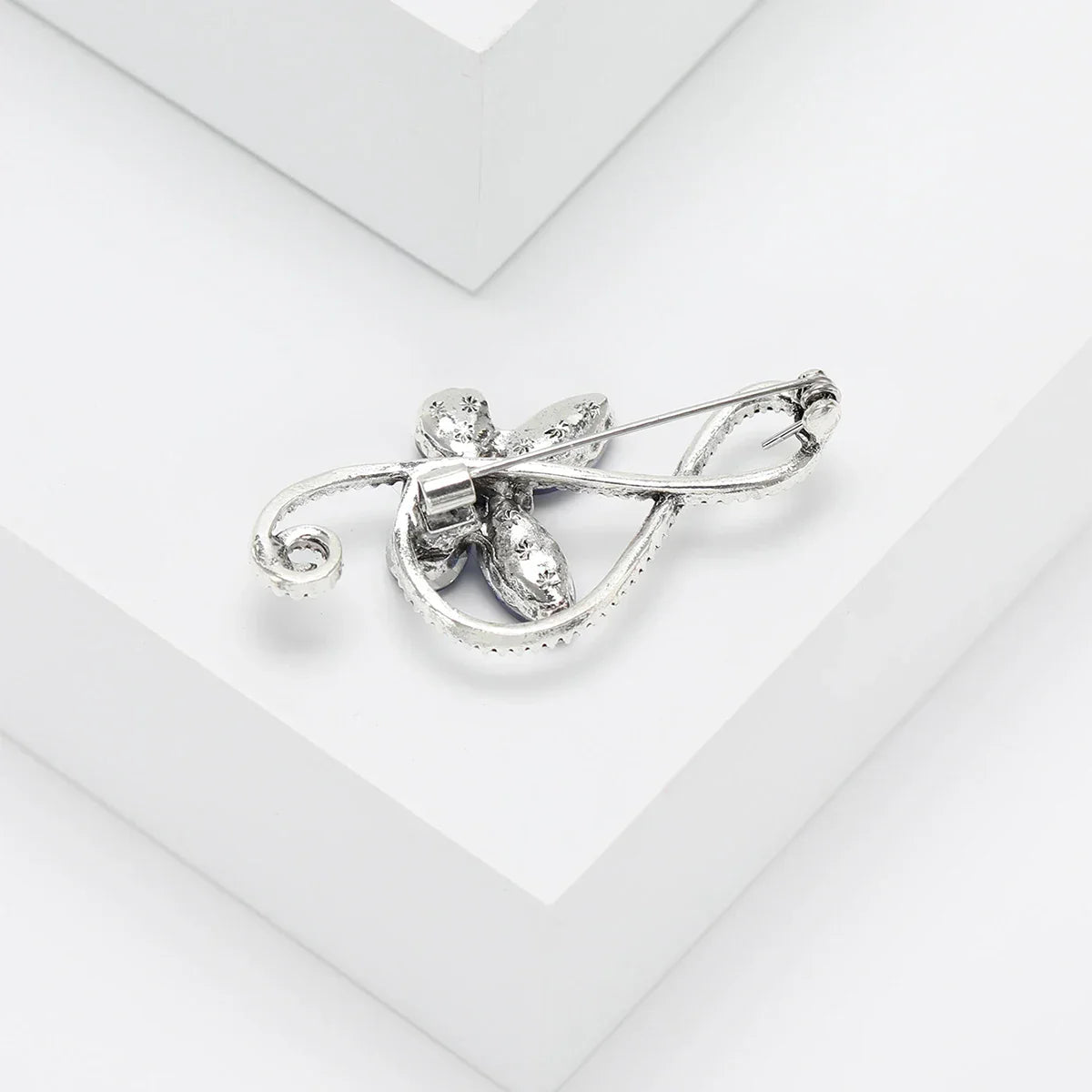 Silver floral brooch with intricate detailing and sparkling gemstones for event party backpack decoration accessories