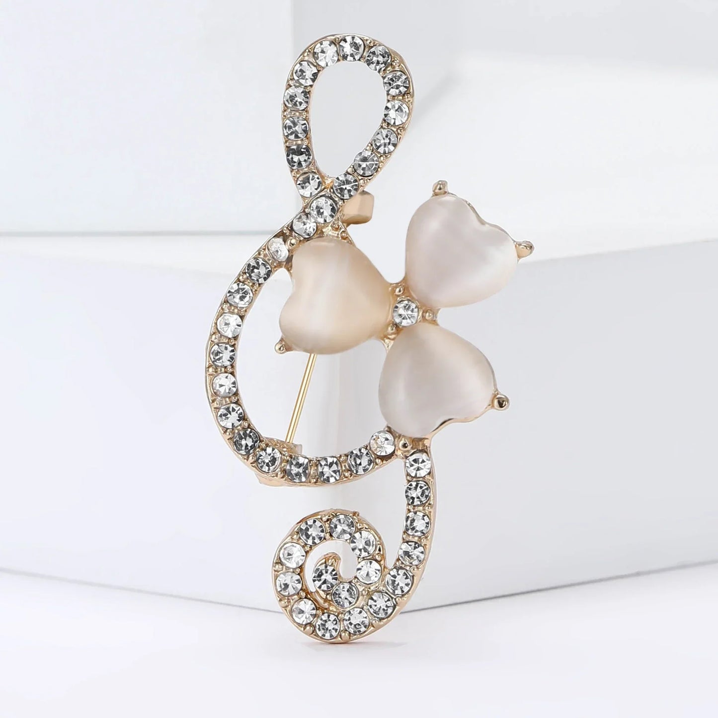 A delicate gold-tone shiny glass musical note brooch with rhinestone butterfly pins and pearlescent beads for event party backpack decoration