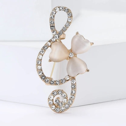 A delicate gold-tone shiny glass musical note brooch with rhinestone butterfly pins and pearlescent beads for event party backpack decoration