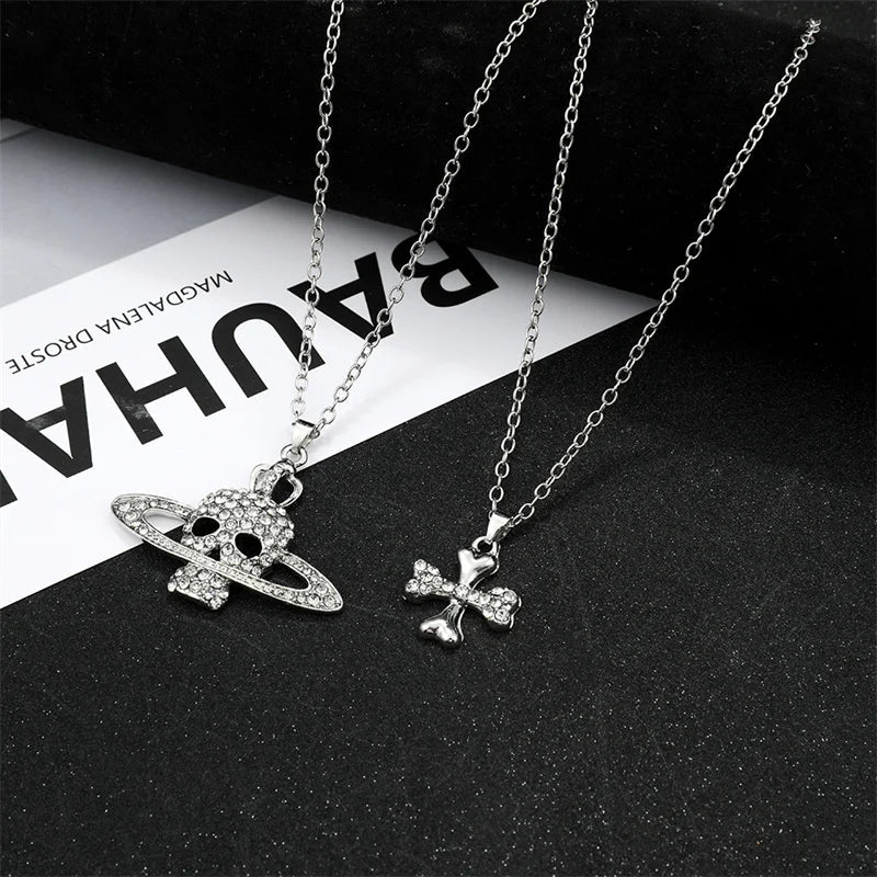 Silver-plated chain necklace vintage featuring a rhinestone skull pendant with orbiting ring and four-leaf clover in punk goth style
