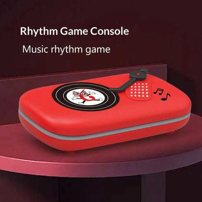 Red plastic rhythm master music game console shaped like vintage record player with black and white vinyl design