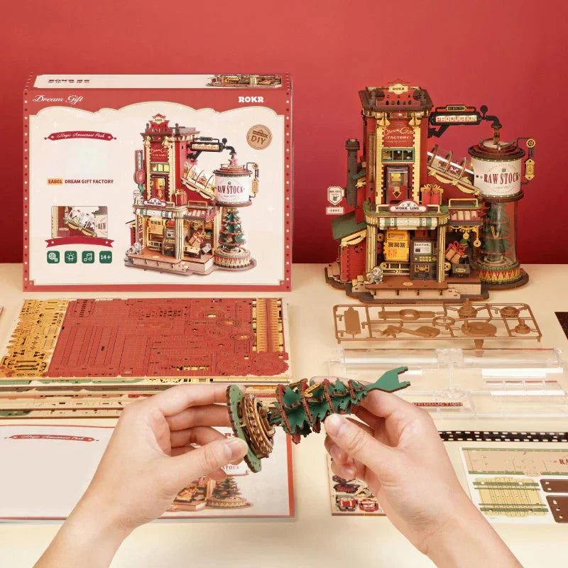 A completed red and gold wooden 3d dream gift factory music box model by Robotime rokr warehouse diy assemble toy