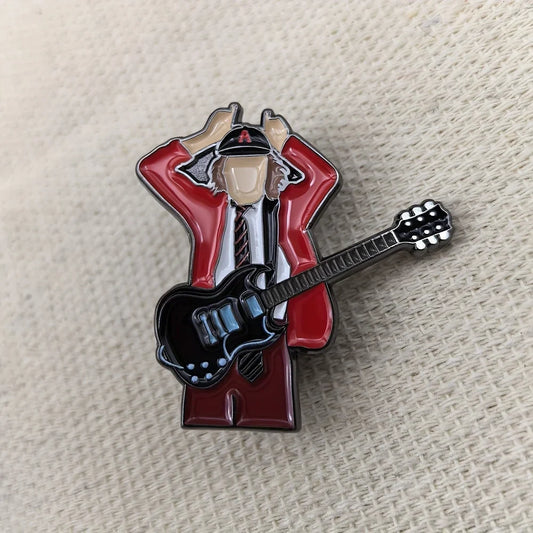 Red and black enamel pin of a stylized guitarist in red jacket white shirt and tie for rock band fans gift and decoration