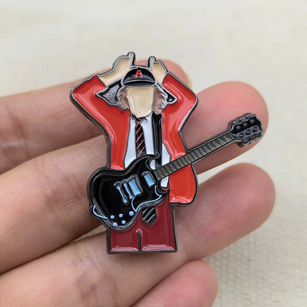 Red enamel pin of a guitarist figure in red jacket holding a black electric guitar with blue accents for music fans gift