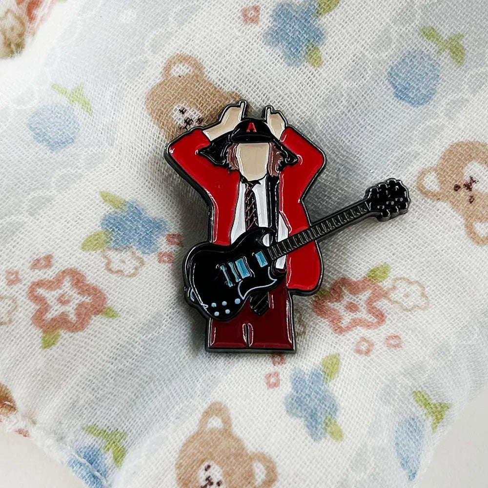 Red and black enamel pin music badge featuring badge guitarist angus in red jacket holding electric guitar for fans gift