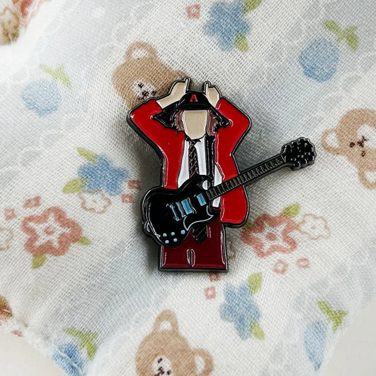Red and black enamel pin music badge featuring badge guitarist angus in red jacket holding electric guitar for fans gift