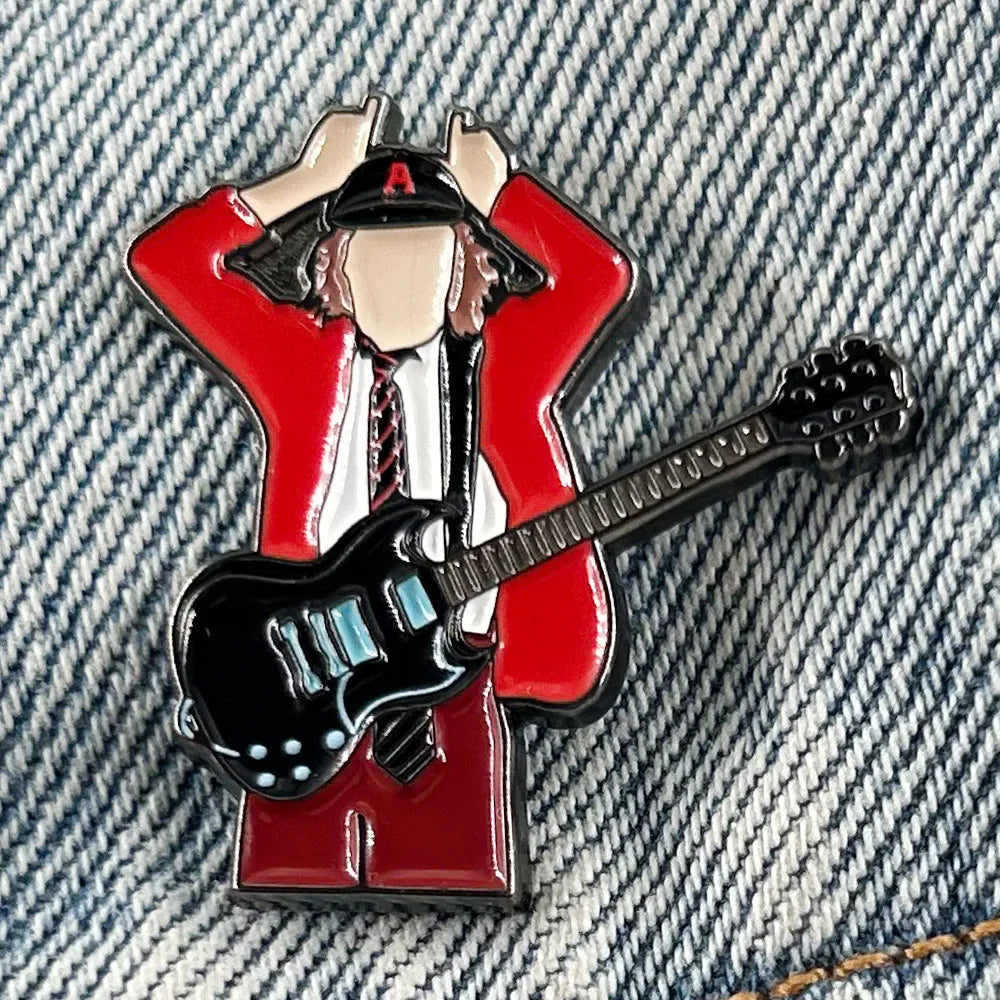 Red enamel pin music badge featuring badge guitarist angus young in red jacket holding black electric guitar