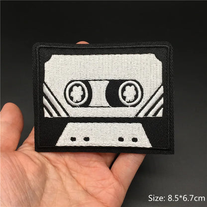 Black and white embroidered punk patches shaped like a cassette tape with stitched details for clothing diy appliques