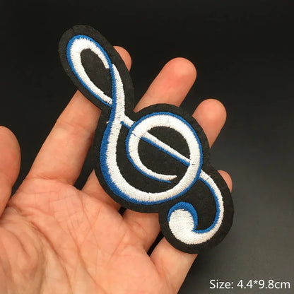 Black embroidered punk patch featuring a treble clef with white and blue guitar stripes iron on clothing diy appliques