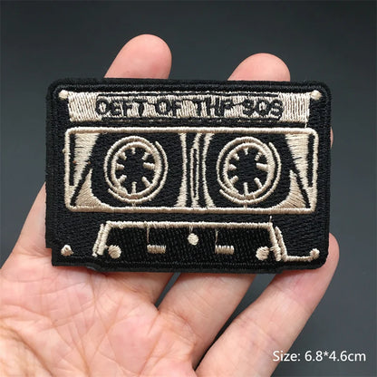 Black and beige embroidered punk patch shaped like cassette tape with out of the 90s for clothing diy appliques