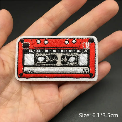 Red and white embroidered punk patch shaped like a cassette tape for clothing diy appliques and guitar stripes iron use