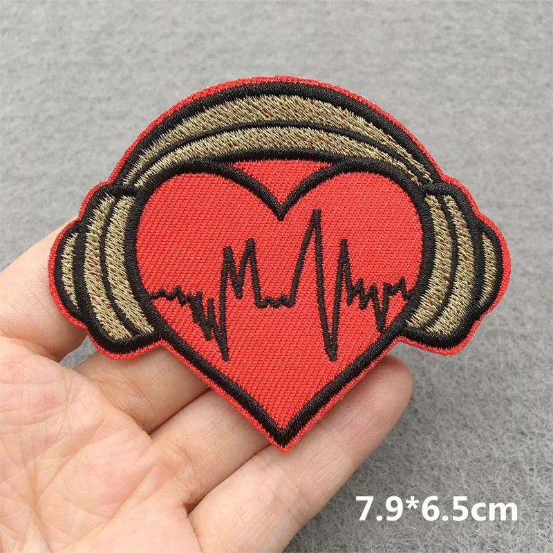 Red heart-shaped music embroidered patch with beige headphones and black heartbeat line for jacket jeans headset