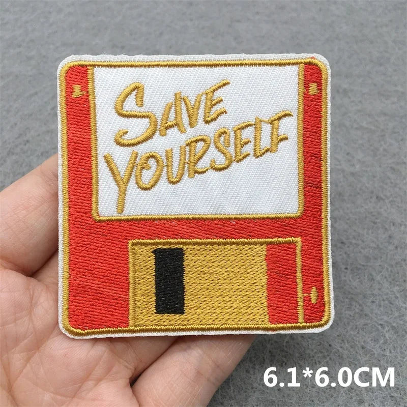 A red and white vintage floppy disk patch with gold save yourself lettering for music embroidered patches and jacket jeans headset