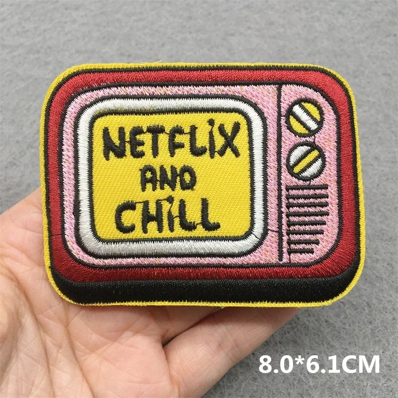 Pink and yellow embroidered patch shaped like a retro television with netflix and chill lettering for jacket jeans headset clothes stickers diy