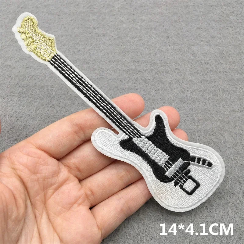 A white embroidered patch shaped like a black electric guitar with silver pickguard for music embroidered patches clothes stickers diy jacket jeans headset