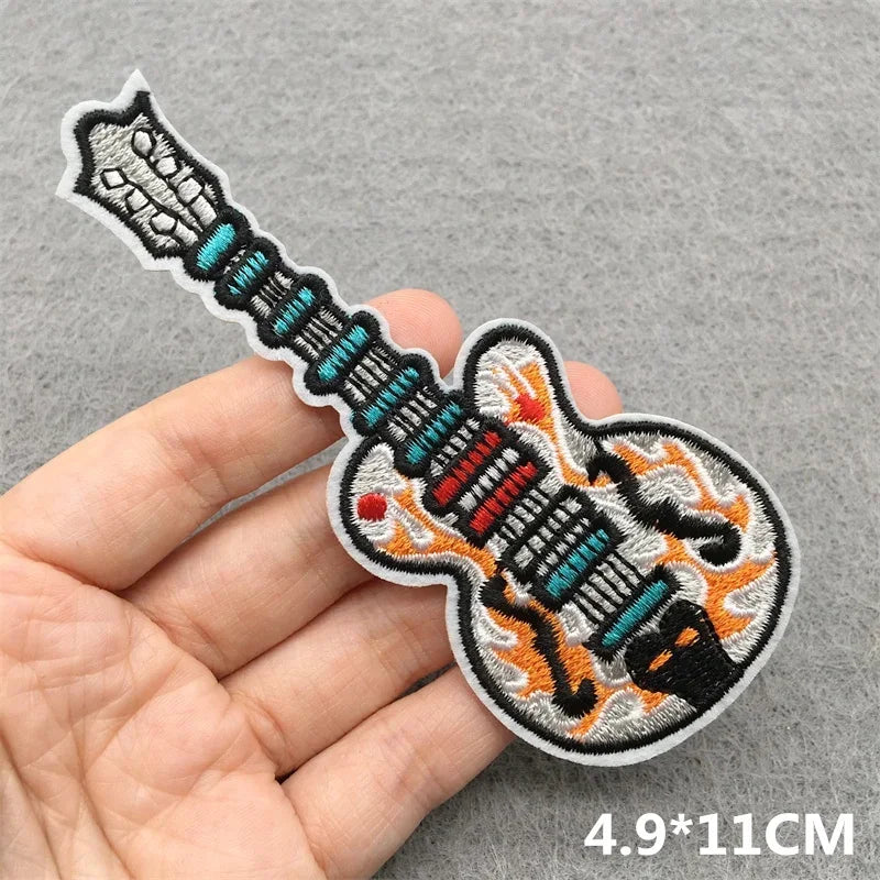 A colorful embroidered music patch with teal red and orange flames for clothes stickers diy on jackets jeans and headsets