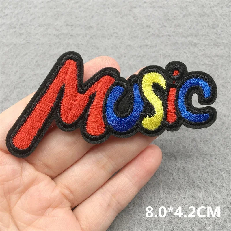 A colorful music embroidered patch with bold red blue and yellow stitching and black outline for jacket jeans headset clothes stickers diy