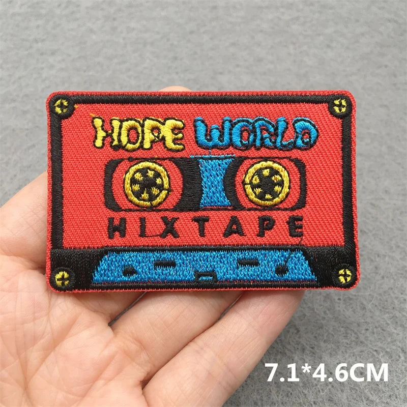 A vibrant red and blue music embroidered patch shaped like a cassette tape for clothes stickers diy jacket jeans headset