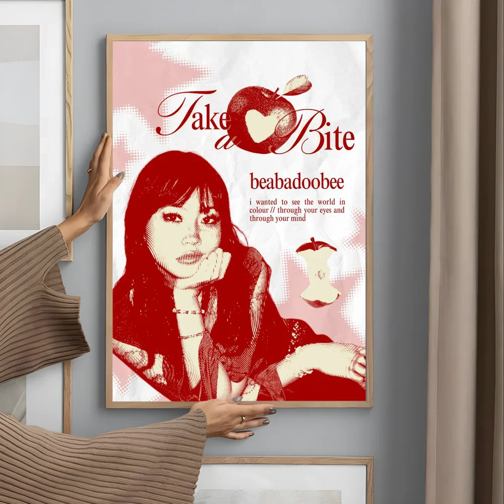A framed red and white modern graphic poster of a woman with apple motif for living room wall art and garage decor