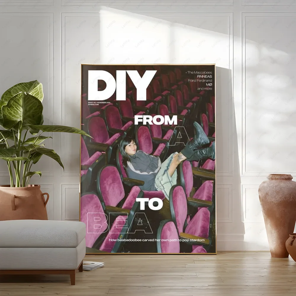 A framed diy magazine cover poster featuring a woman in vibrant pink theater seats with bold white text modern graphic for living room wall art
