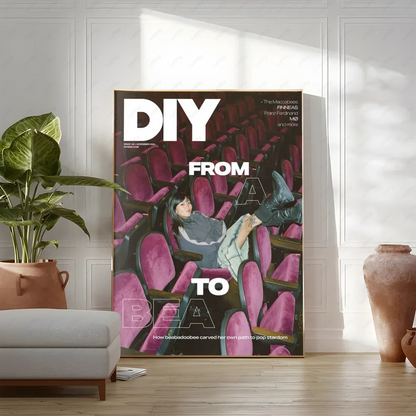 A framed diy magazine cover poster featuring a woman in vibrant pink theater seats with bold white text modern graphic for living room wall art