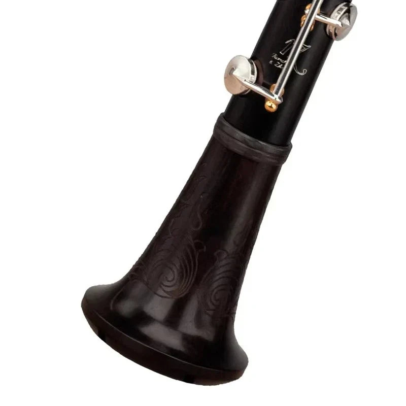 Black wooden clarinet solo black with silver and gold keys and engraved swirl patterns from products ebony series