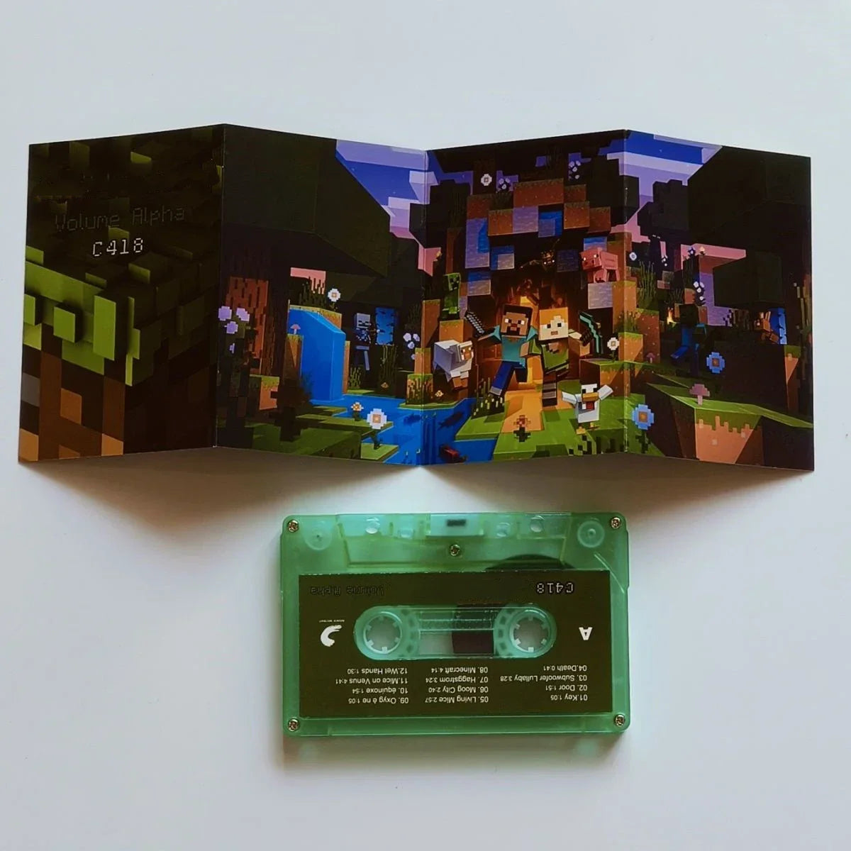 Green transparent cassette tape with black label and pixelated minecraft-themed fold-out album cover for daniel rosenfeld music