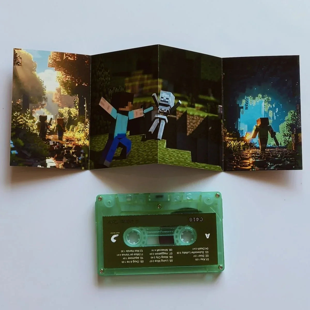 Green transparent cassette tape with black label and printed tracklist featuring daniel rosenfeld music for sandbox game album cassettes cosplay