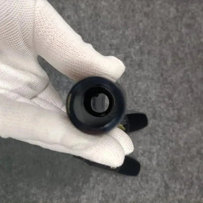 A sleek glossy black cylindrical saxophone head curdlin with a smooth polished surface and central hole for al5 alto saxophone